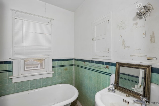 bathroom featuring tile walls and a bathing tub