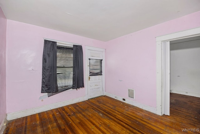 empty room with dark hardwood / wood-style floors