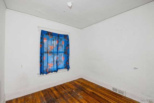 spare room with wood-type flooring