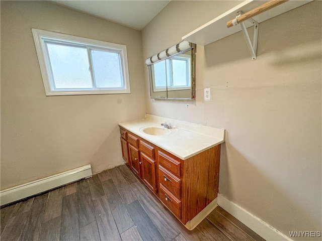 bathroom with vanity, hardwood / wood-style floors, and baseboard heating