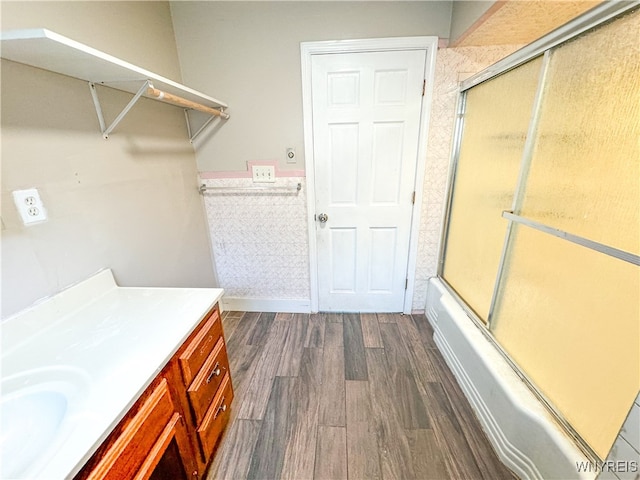 bathroom with vanity, enclosed tub / shower combo, and hardwood / wood-style flooring