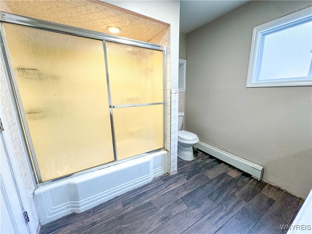 bathroom with toilet, a baseboard radiator, hardwood / wood-style floors, and bath / shower combo with glass door