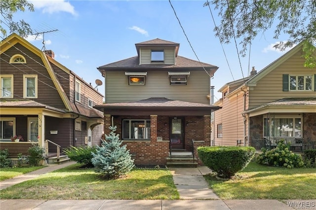 view of front of home with a porch and a front yard