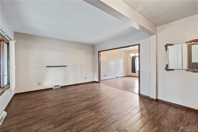 interior space featuring dark wood-type flooring and a chandelier