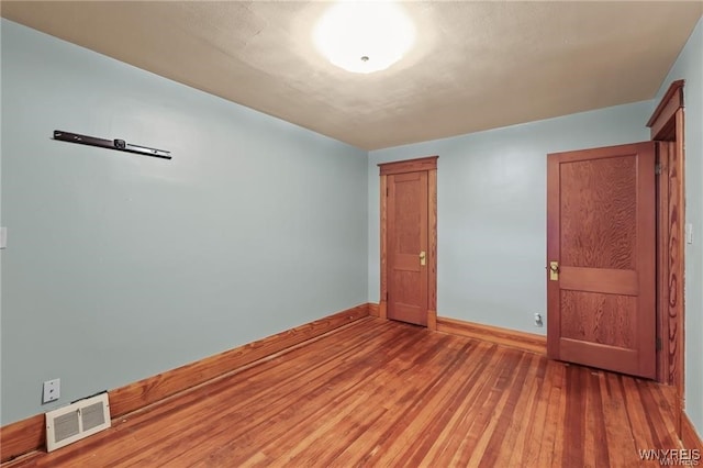 empty room with wood-type flooring