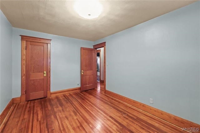 unfurnished bedroom with hardwood / wood-style floors