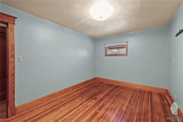 unfurnished room with wood-type flooring