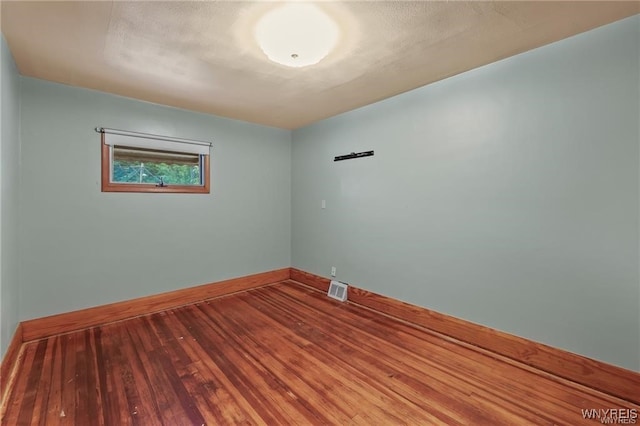 unfurnished room with hardwood / wood-style floors