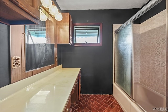 bathroom with vanity, enclosed tub / shower combo, and tile patterned floors