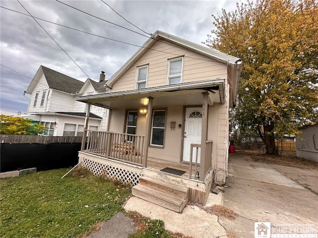 bungalow-style home featuring a porch and a front yard