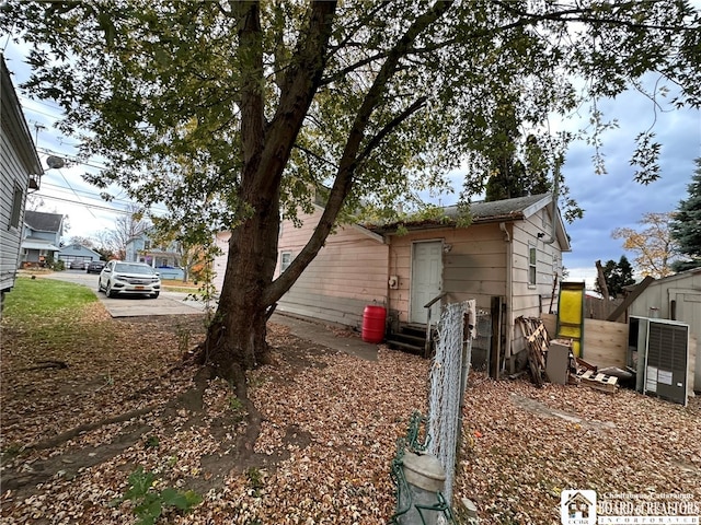 view of property exterior with a shed