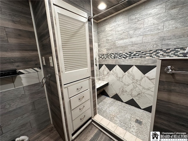 bathroom with a shower and wood-type flooring