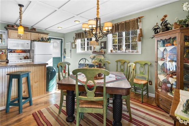 399 Fire Lane 34, Moravia, NY 13118 - dining room featuring a notable chandelier, light wood-type flooring, and baseboards