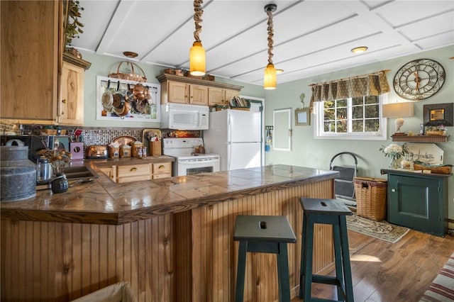 399 Fire Lane 34, Moravia, NY 13118 - kitchen featuring a breakfast bar, white appliances, decorative backsplash, and wood finished floors