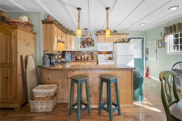 399 Fire Lane 34, Moravia, NY 13118 - kitchen with white appliances, a sink, a peninsula, wood finished floors, and backsplash