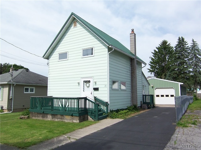 view of front of house featuring an outdoor structure, a front yard, and a garage