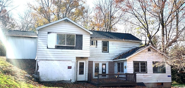 rear view of property featuring a deck