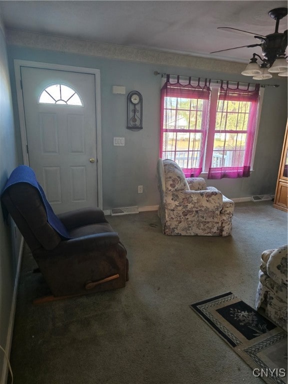 carpeted foyer with ceiling fan