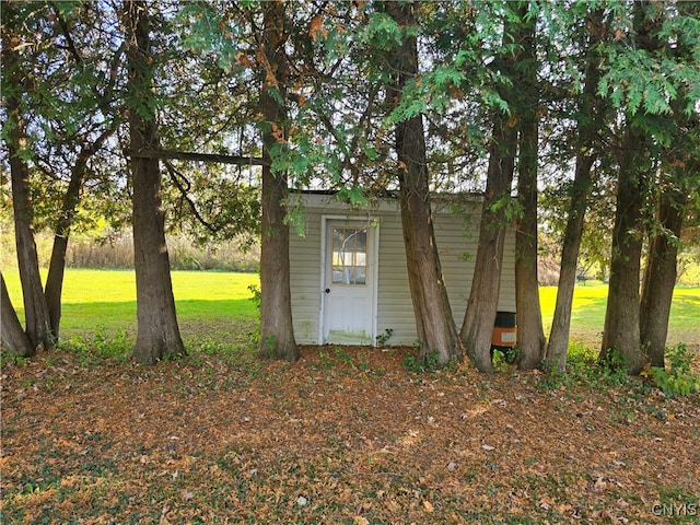 view of outbuilding with a lawn