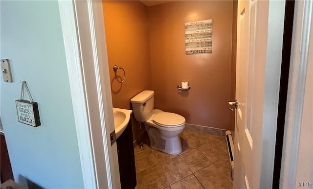 bathroom featuring toilet, vanity, and tile patterned flooring