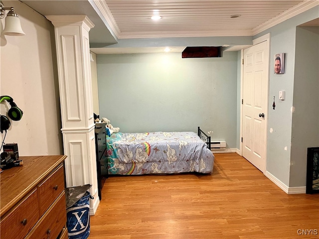 bedroom featuring light hardwood / wood-style flooring, ornamental molding, and ornate columns