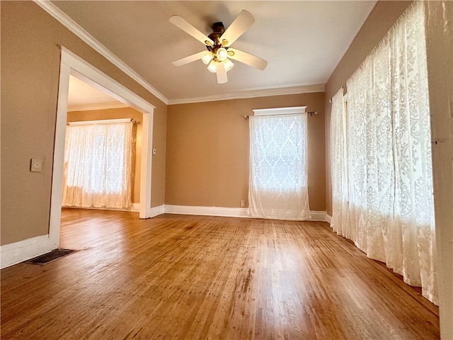 spare room featuring crown molding, hardwood / wood-style flooring, and ceiling fan