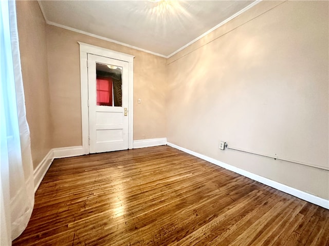 unfurnished room with ornamental molding and hardwood / wood-style flooring