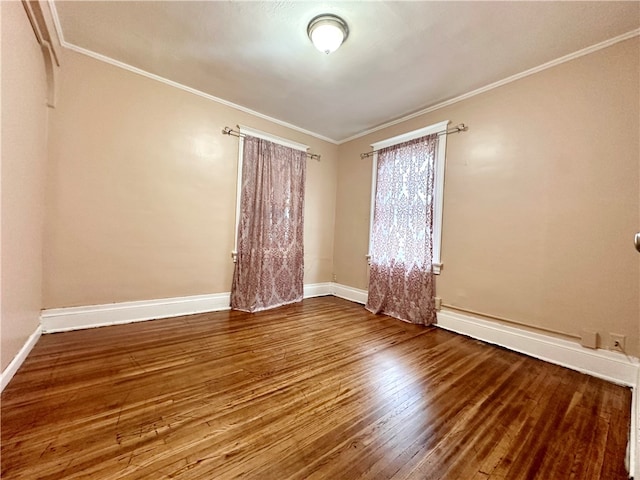 empty room with crown molding and hardwood / wood-style flooring