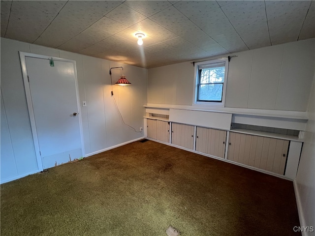 basement with dark colored carpet