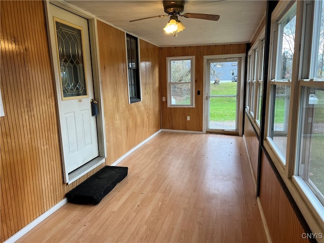 unfurnished sunroom with ceiling fan and a wealth of natural light