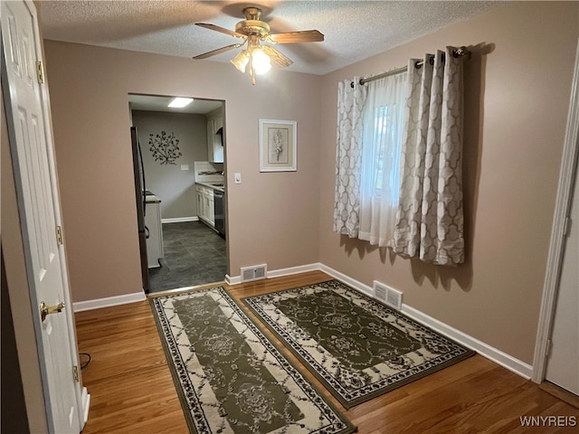 interior space featuring a textured ceiling and hardwood / wood-style flooring