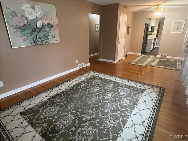 corridor with hardwood / wood-style floors