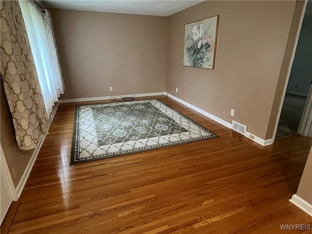 spare room with hardwood / wood-style floors