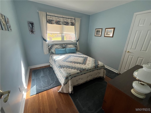 bedroom with hardwood / wood-style floors