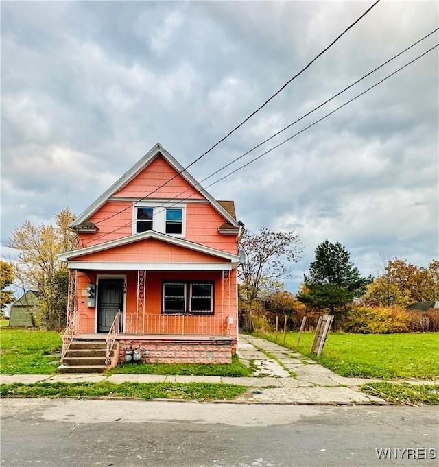 view of front facade with a porch and a front lawn