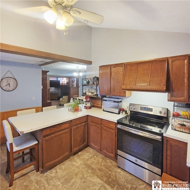 kitchen featuring kitchen peninsula, premium range hood, a breakfast bar, vaulted ceiling, and stainless steel range with electric stovetop