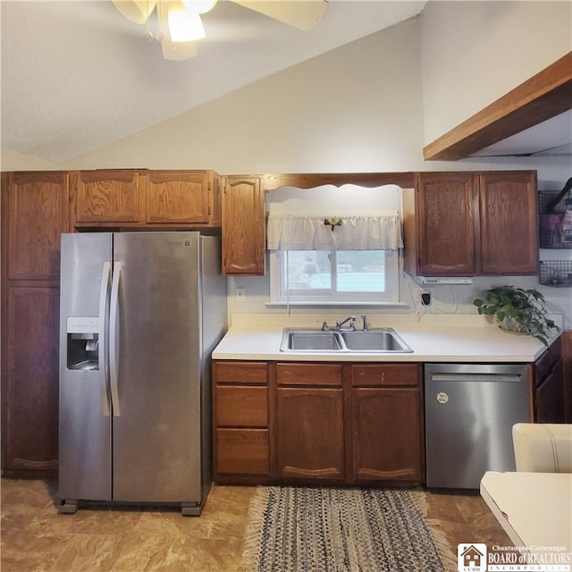 kitchen featuring appliances with stainless steel finishes, lofted ceiling, sink, and ceiling fan