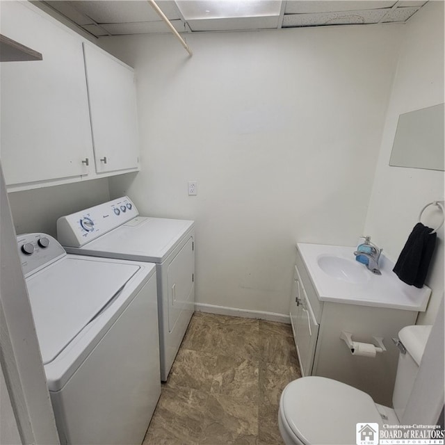 clothes washing area featuring independent washer and dryer and sink