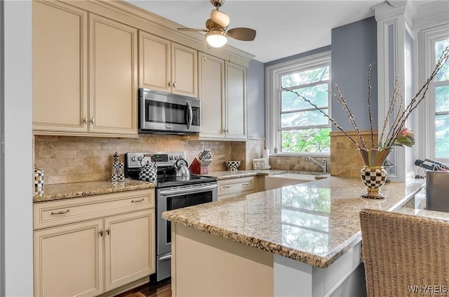 800 W Ferry St Unit 2Cc, Buffalo, NY 14222 - kitchen with stainless steel appliances, cream cabinets, and decorative backsplash