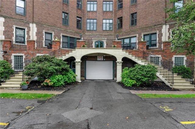 800 W Ferry St Unit 2Cc, Buffalo, NY 14222 - view of front facade with stairs, brick siding, and an attached garage