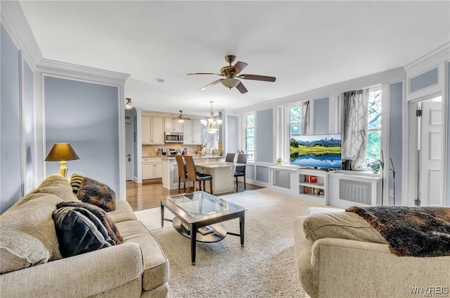 800 W Ferry St Unit 2Cc, Buffalo, NY 14222 - living room with a chandelier, ceiling fan, healthy amount of natural light, crown molding, and baseboards