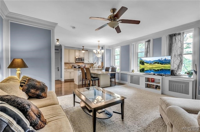 800 W Ferry St Unit 2Cc, Buffalo, NY 14222 - living room featuring crown molding, a ceiling fan, plenty of natural light, a chandelier, and radiator heating unit