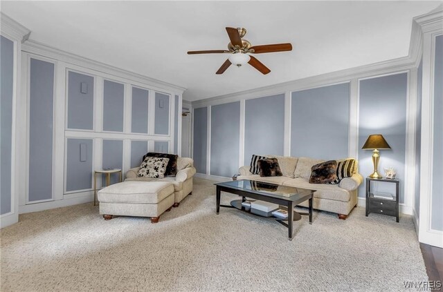 carpeted living room featuring crown molding and ceiling fan