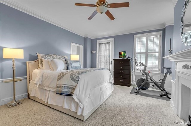 carpeted bedroom with ornamental molding and ceiling fan