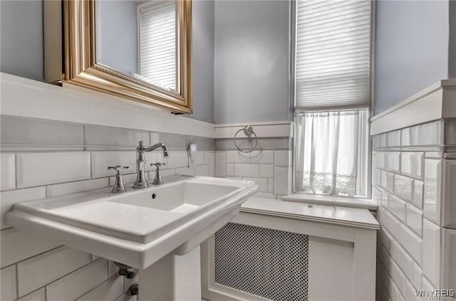 800 W Ferry St Unit 2Cc, Buffalo, NY 14222 - bathroom with tile walls, a sink, and a wainscoted wall