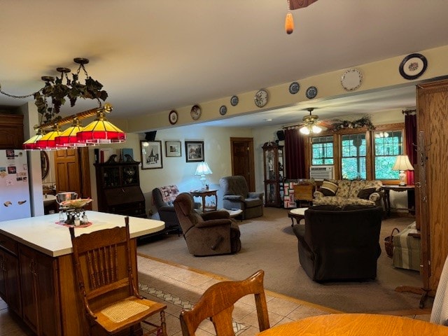 living room featuring light tile patterned floors and ceiling fan