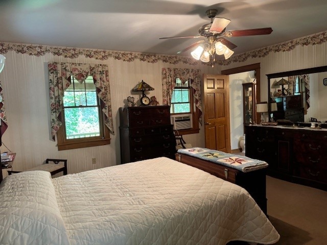 carpeted bedroom featuring cooling unit and ceiling fan