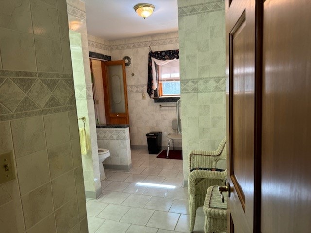 bathroom featuring tile walls, toilet, and tile patterned flooring