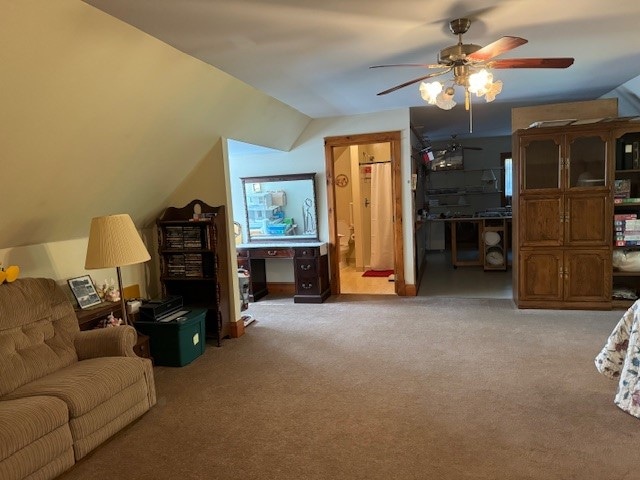 carpeted living room featuring lofted ceiling and ceiling fan