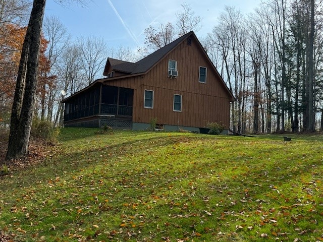 view of property exterior with a yard and a sunroom